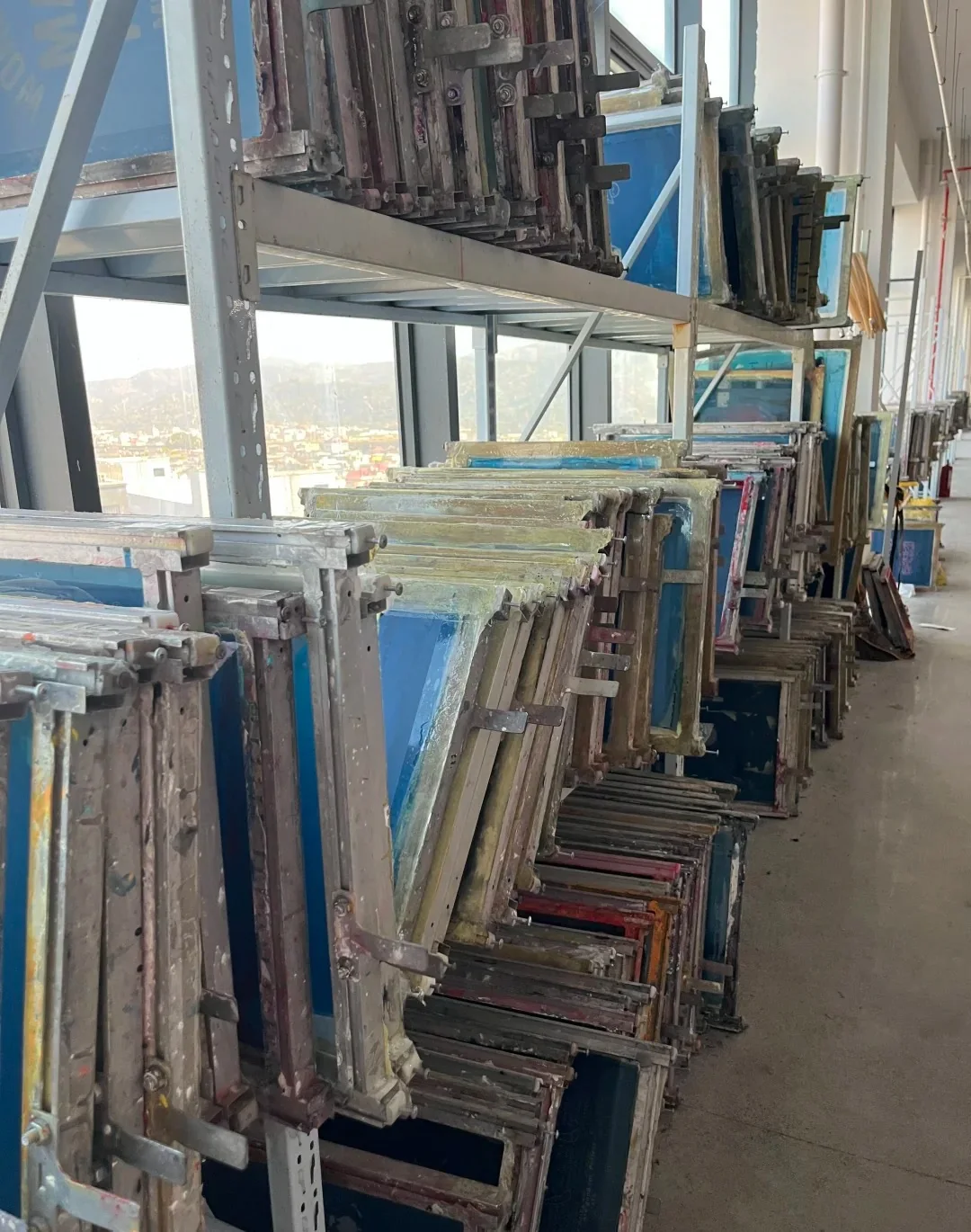 screen printing screens stored on rack