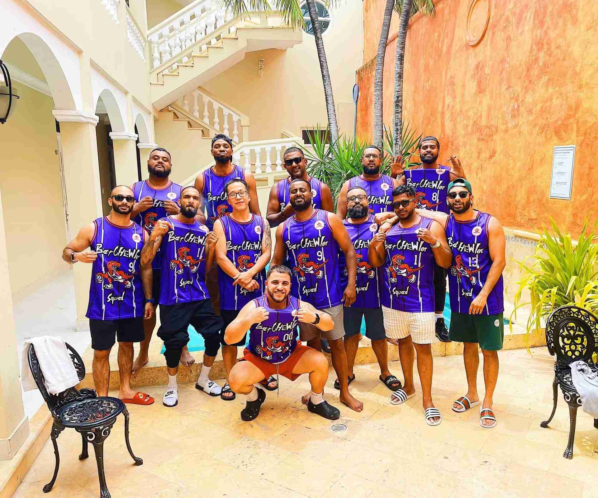 A group wearing matching purple basketball jerseys in a courtyard