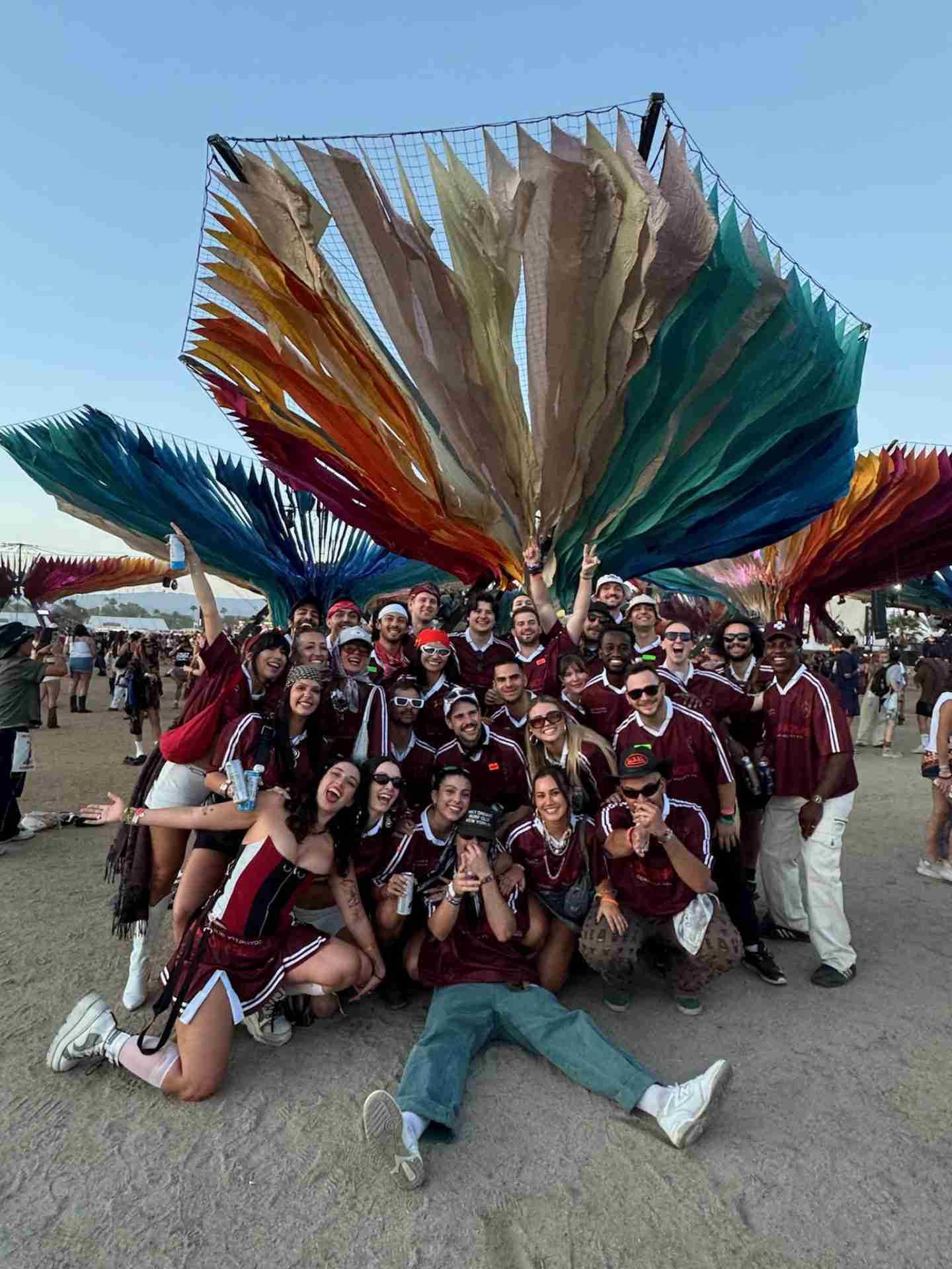 A group wearing coordinated burgundy jerseys at an outdoor event
