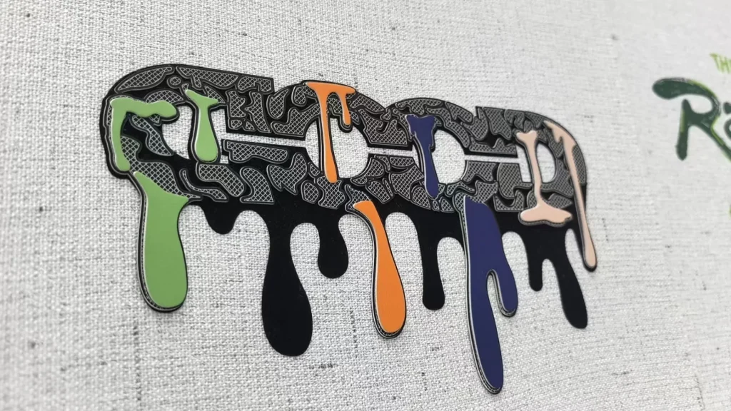 3D silicone heat transfer logo with coloured drip details and textured lettering